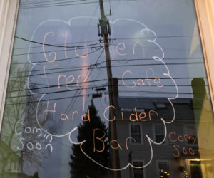 Writing on a window announces that a gluten-free cafe and hard cider bar will soon open at 133 Main St. in downtown Damariscotta. The business, Butter Up Cakes, has roots in Bangor. (Hailey Bryant photo)