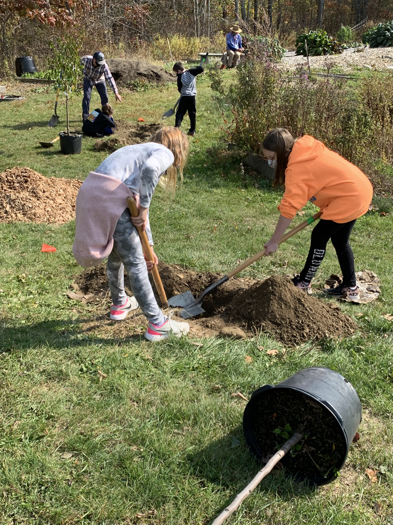 Students prepare to plant trees in a new orchard behind Great Salt Bay Community School in Damariscotta. The school plans to set up a greenhouse near the orchard by fall 2021. (Photo courtesy Margaret Coleman)