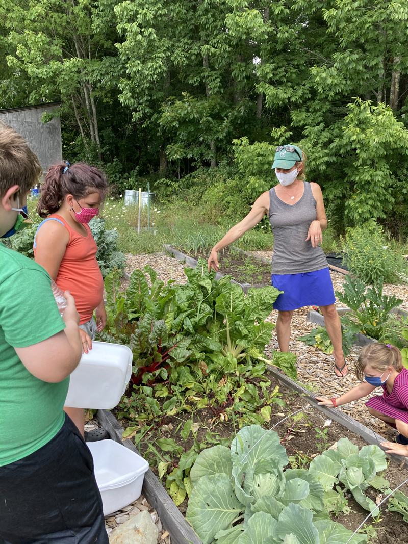 Margaret Coleman, agriculture coordinator at Great Salt Bay Community School in Damariscotta, shows summer campers the garden behind the school. The school plans to put up a greenhouse close to the garden by fall 2021. (Photo courtesy Margaret Coleman)