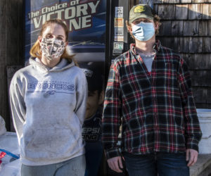 Griffen Bond, right, and Caitlyn Butler pose in front of Jefferson Redemption in Jefferson on Tuesday, Dec. 29. Bond partnered with Butler, the owner of the redemption center, to start a bottle drive to benefit Gage York, a Nobleboro teenager injured in a car crash. (Bisi Cameron Yee photo)