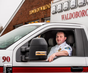 Derek Booker at the wheel of an ambulance outside the Waldoboro station, Sunday, Dec. 13. Born and raised in Waldoboro, Booker was recently promoted to deputy director of Waldoboro Emergency Medical Services. (Bisi Cameron Yee photo)
