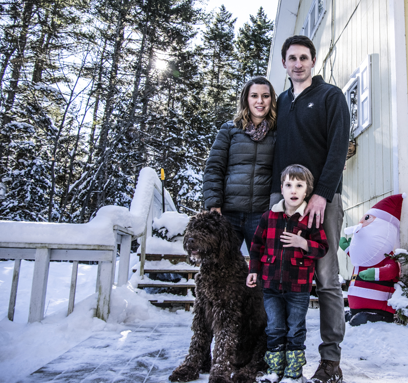 Hayden Libby poses for a family photo with parents Sheila and Ross, and best friend Hershey. Hershey is a Newfoundland-poodle mix who became a member of the family last spring. (Bisi Cameron Yee photo)