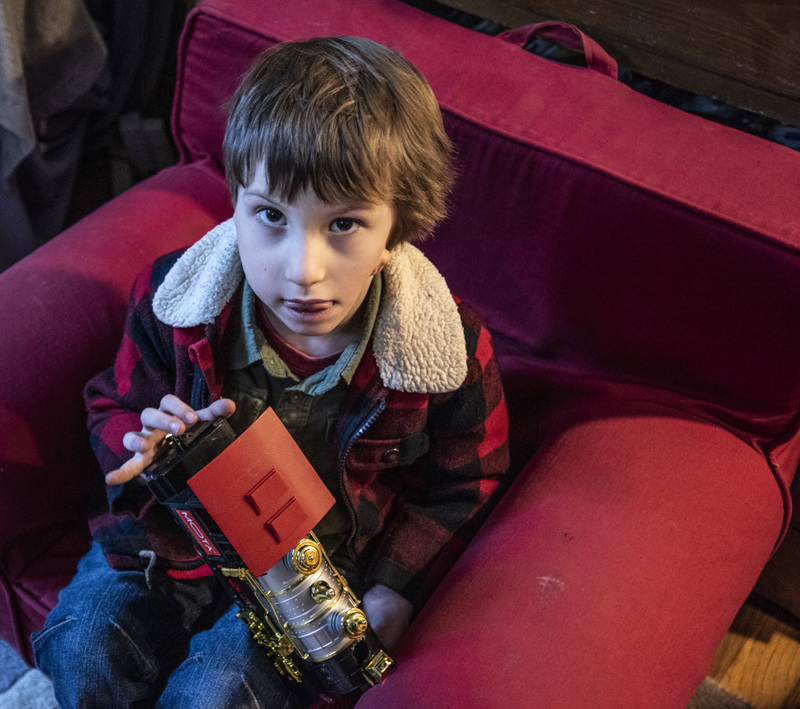 Hayden Libby, 5, holds a toy locomotive in Waldoboro on Saturday, Dec. 19. Libby's favorite toys are dinosaurs and anything with wheels. (Bisi Cameron Yee photo)