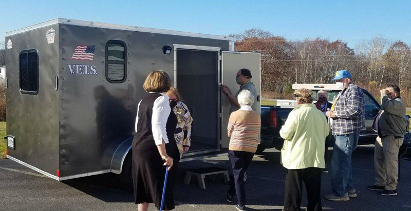 Representatives of Veterans Emergency Temporary Shelters show one of the program's trailers to members of the local Daughters of the American Revolution chapter.