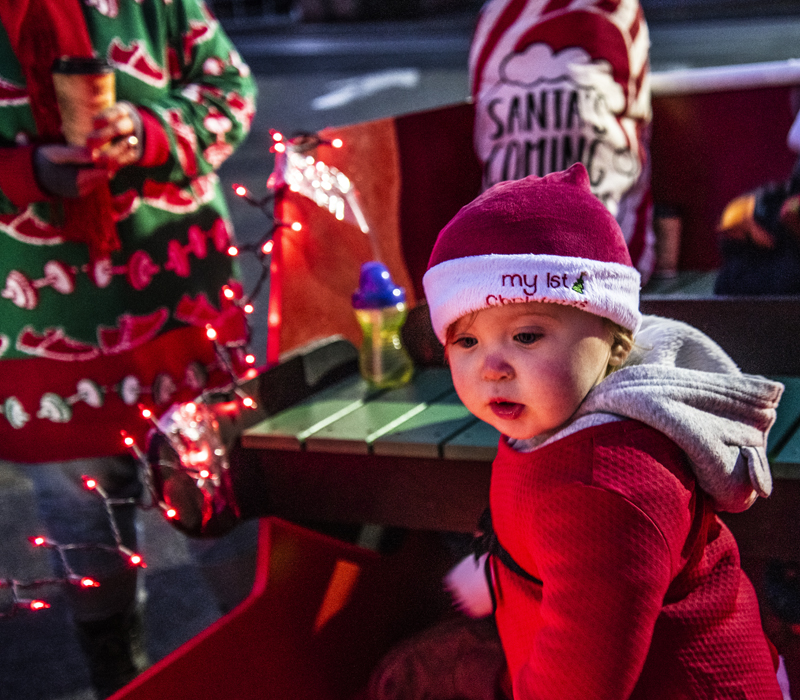 Magnolia Poulin, 14 months, explores the inside of the Renys sleigh during the Villages of Light reverse parade at Lincoln Academy in Newcastle on Saturday, Nov. 28. Magnolia delighted in waving at the hudreds of cars participating. (Bisi Cameron Yee photo)