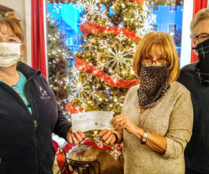 From left: Tammy Walsh, of Midcoast Humane, accepts a check from Stars Fine Jewelry co-owners Frieda and John Hanlon.