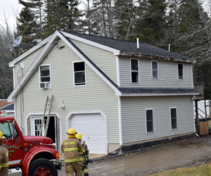 Firefighters clean up after a kitchen fire at 21 West Side Road on Barter's Island, Boothbay, Thursday, Dec. 31. Firefighters knocked down the second-floor blaze within about 15 minutes, Chief Dick Spofford said. (Evan Houk photo)