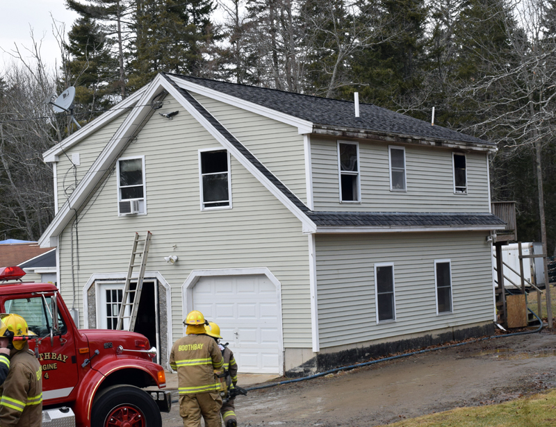 Firefighters clean up after a kitchen fire at 21 West Side Road on Barter's Island, Boothbay, Thursday, Dec. 31. Firefighters knocked down the second-floor blaze within about 15 minutes, Chief Dick Spofford said. (Evan Houk photo)