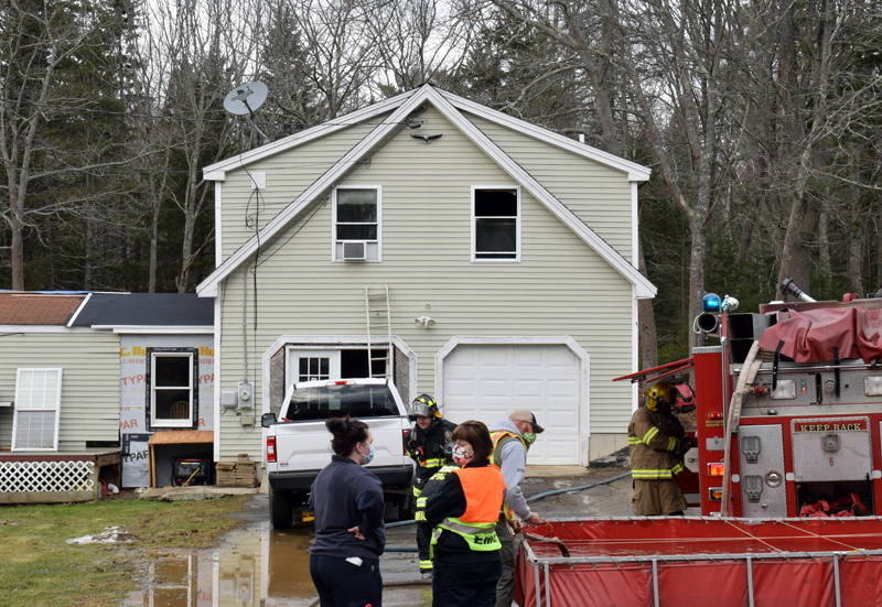 First responders work at the scene of a house fire at 21 West Side Road on Barter's Island, Boothbay, Thursday, Dec. 31. A dog and a cat perished from smoke inhalation, according to Boothbay Fire Chief Dick Spofford. (Evan Houk photo)