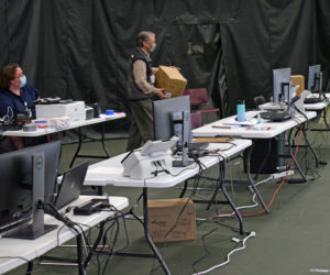 LincolnHealth employees set up a screening station for a vaccination clinic at the Marylouise Tandy Cowan Fieldhouse at the Boothbay Region YMCA on Wednesday, Jan. 20. The clinic will have vaccinated 1,000 individuals by the end of the week after starting on Monday, Jan. 25, according to John Martins, spokesperson for LincolnHealth. (Evan Houk photo)