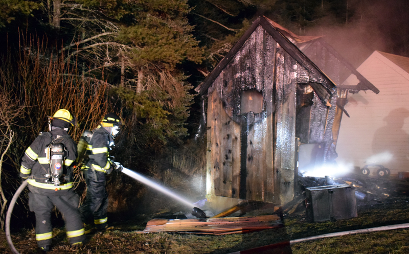 Firefighters mop up after a fire in a sauna behind a home at 153 West Old County Road in Newcastle on Thursday, Jan. 21. A quick response minimized heat damage to the house and a shed. (Evan Houk photo)