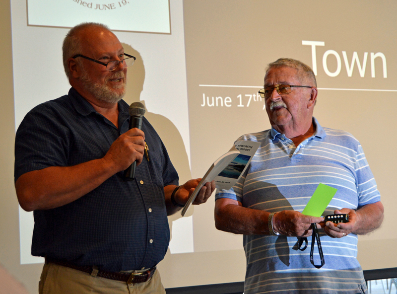 Newcastle Board of Selectmen Chair Brian Foote (left) dedicates the annual town report to Allan Ray at annual town meeting on June 17, 2019. Foote plans to resign from the board. (Evan Houk photo, LCN file)