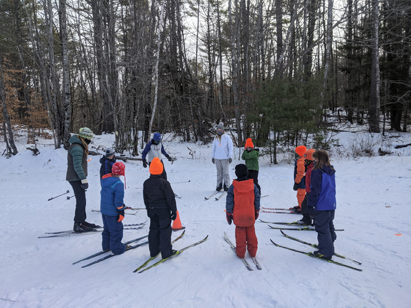 Youth cross-country ski clinic circles up for their ski lesson at HVNC. (Photo courtesy Anna Fiedler)