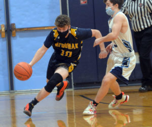 Patrick McKenney brings the ball up the court for Medomak. (Paula Roberts photo)