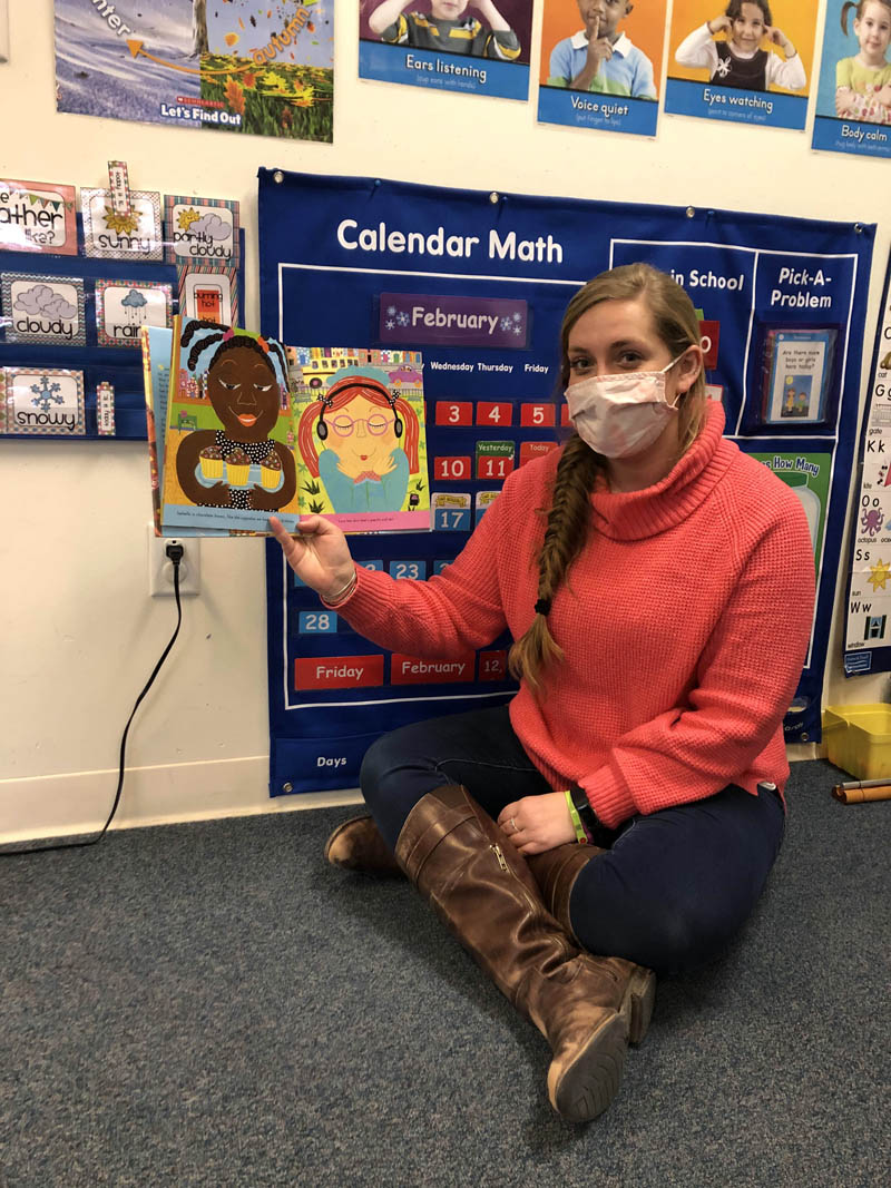 Sally Monroe holds up a picture book in her prekindergarten classroom at Edgecomb Eddy School. (Photo courtesy Sally Monroe)