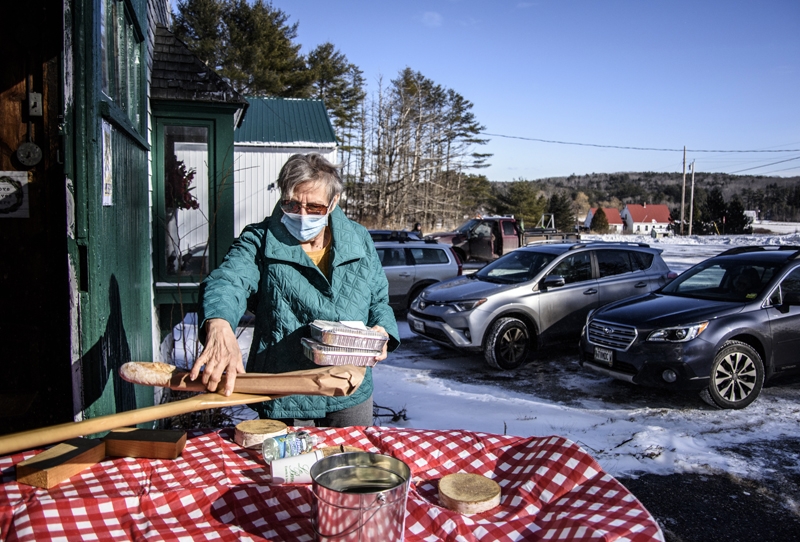 Barbara Zucchi picks up a couple of meals at Le Barn in Jefferson on Friday, Jan. 29. Over 100 meals were sold in less than two hours. (Bisi Cameron Yee photo)
