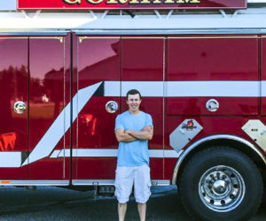 Oakley Oliver, of Jefferson, poses in front of a fire truck on his first day as a live-in trainee at the Gorham Fire Department. Oliver recently assisted in the rescue of an injured snowmobiler in Rangeley. (Photo courtesy Jen Oliver)