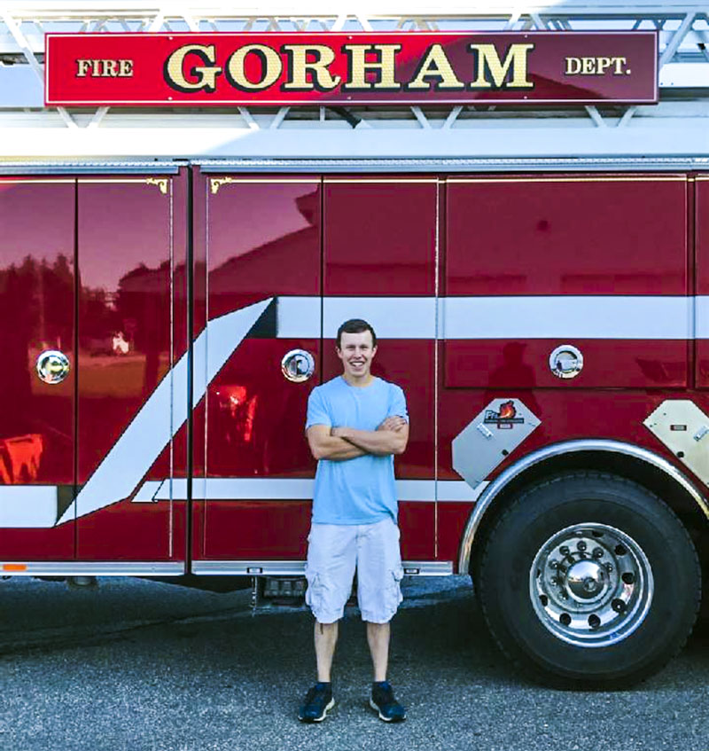 Oakley Oliver, of Jefferson, poses in front of a fire truck on his first day as a live-in trainee at the Gorham Fire Department. Oliver recently assisted in the rescue of an injured snowmobiler in Rangeley. (Photo courtesy Jen Oliver)