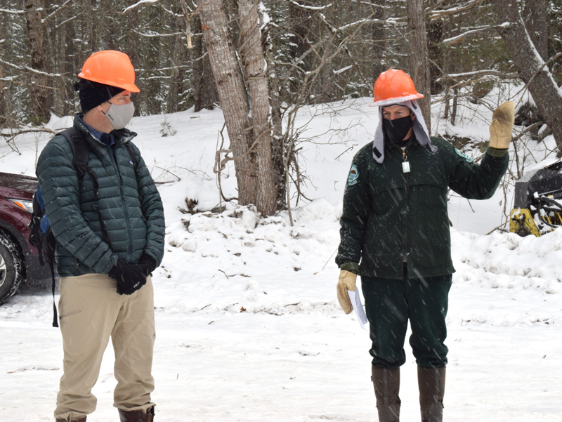 From left: Coastal Rivers Conservation Trust Executive Director Steven Hufnagel looks on as Stephen Richardson, senior forest engineer with the Maine Bureau of Parks and Lands, discusses the ongoing timber harvest at Dodge Point Public Reserved Land in Newcastle during a tour Tuesday, Feb. 10. (Evan Houk photo)