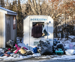 A clothing donation bin overflows in Waldoboro on Monday, Feb. 1. Residents have complained about the state of the bin, but the Waldoboro Free Clothing Closet suspended operations in March and posted signs to that effect. (Bisi Cameron Yee photo)