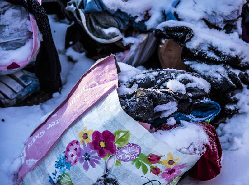 A bag of clothing is part of a pile of items outside a collection bin in Waldoboro on Monday, Feb. 1. The Waldoboro Free Clothing Closet has plans to reopen in the spring, but is not currently accepting donations. (Bisi Cameron Yee photo)