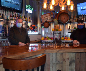 Dana Long (left) and Michael Collins stand behind the bar at the Barnhouse Grill & Pub in Wiscasset. Long and Collins own the restaurant with a third partner, Daniel Dyer. (Charlotte Boynton photo)