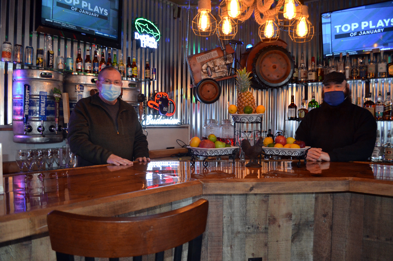 Dana Long (left) and Michael Collins stand behind the bar at the Barnhouse Grill &  Pub in Wiscasset. Long and Collins own the restaurant with a third partner, Daniel Dyer. (Charlotte Boynton photo)