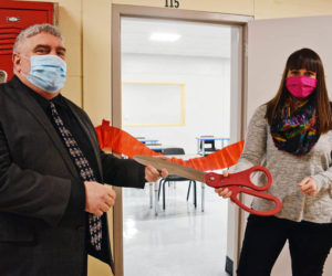 Wiscasset Middle High School Principal Charles Lomonte and health teacher Elizabeth Hemdal participate in a ribbon-cutting ceremony for the school's new classroom Monday, Feb. 22. (Hailey Bryant photo)