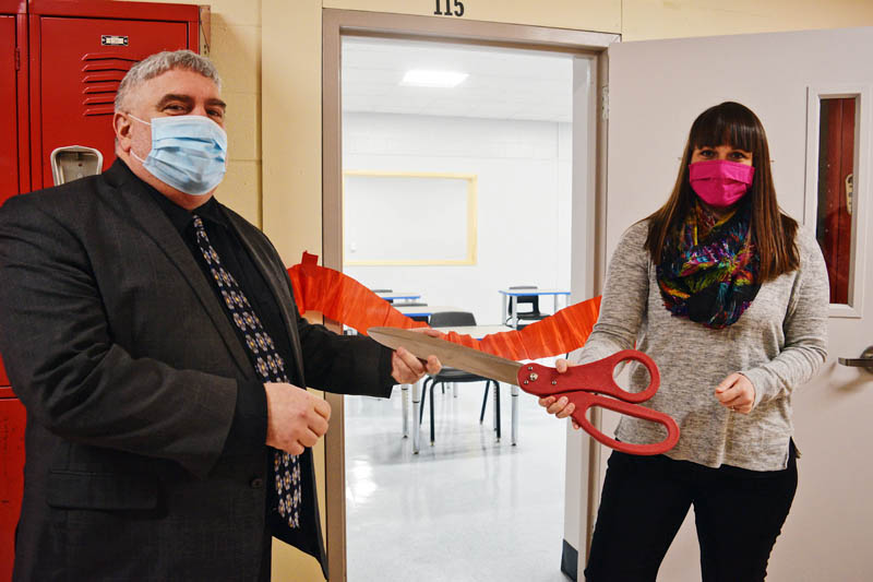 Wiscasset Middle High School Principal Charles Lomonte and health teacher Elizabeth Hemdal participate in a ribbon-cutting ceremony for the school's new classroom Monday, Feb. 22. (Hailey Bryant photo)