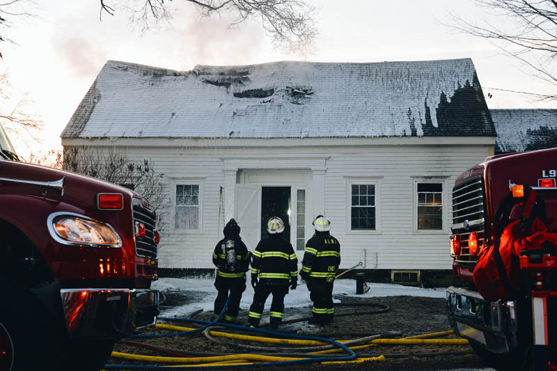 Firefighters spray foam to extinguish a fire at 1817 Alna Road in Alna early Wednesday, March 10. (Hailey Bryant photo)