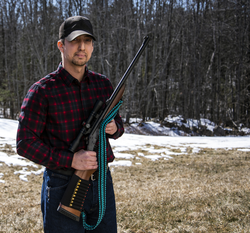 Tyler Richards demonstrates a rifle sling he crafted from paracord in Damariscotta on Monday, March 8. The sling uses over 100 feet of paracord and can be unbraided for use in a survival situation. (Bisi Cameron Yee photo)