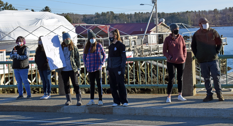 Demonstrators gather on the Damariscotta-Newcastle bridge to voice support for a return to full-time, in-person instruction at Lincoln Academy on Saturday, March 13. (Evan Houk photo)