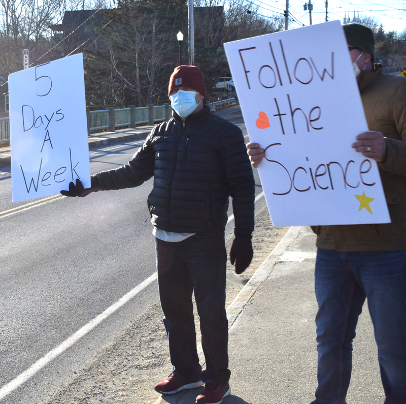 Anthony Anderson, an LA parent and organizer of a demonstration on the Twin Villages bridge, holds a sign expressing support for a return to full-time, in-person instruction at Lincoln Academy on Saturday, March 13. (Evan Houk photo)