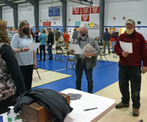 South Bristol Town Clerk Brenda Bartlett swears in new and reelected municipal officers after annual town meeting at South Bristol School on Tuesday, March 9. From left: Bartlett, school committee member Sara Mitchell, Selectman Ken Lincoln, and school committee newcomer James Ready. (Evan Houk photo)