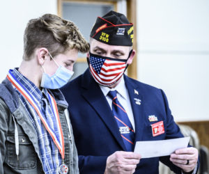 E.J. Hunt (left) receives a $500 check from Patriot's Pen Chair Anthony Kimble at the Veterans of Foreign Wars post in Waldoboro on Thursday, March 11. (Bisi Cameron Yee photo)