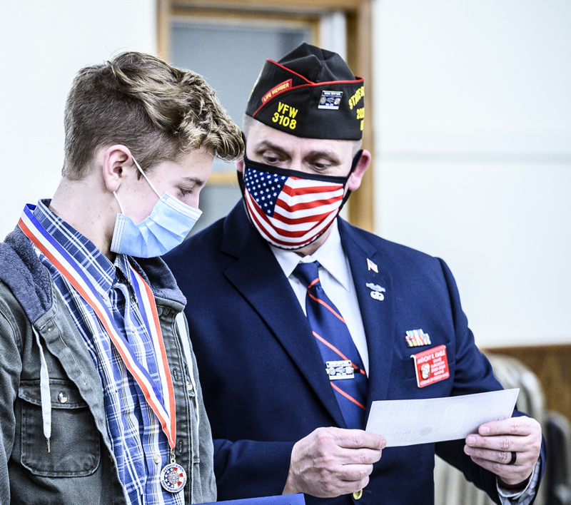 E.J. Hunt (left) receives a $500 check from Patriot's Pen Chair Anthony Kimble at the Veterans of Foreign Wars post in Waldoboro on Thursday, March 11. (Bisi Cameron Yee photo)