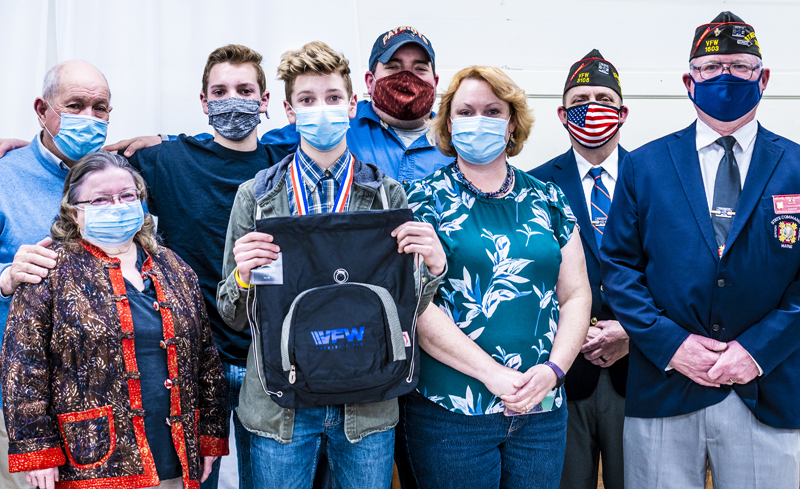 E.J. Hunt (fourth from left) poses with his family and Veterans of Foreign Wars representatives after receiving an award for his essay on patriotism at the VFW post in Waldoboro on Thursday, March 11. (Bisi Cameron Yee photo)