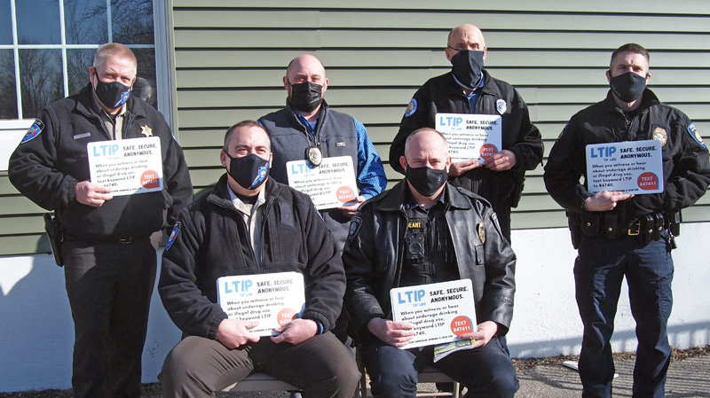 Local law enforcement receive LTIP decals to promote new tip line number. Front row, from left: Lincoln County Sheriff's Office Chief Deputy Rand Maker, Sgt. Perry Hatch of Wiscasset Police Department. Back row, from left: Sheriff Todd Brackett, Damariscotta Police Chief Jason Warlick, Officer Lawrence Brown of Boothbay Harbor Police Department, and Waldoboro Police Chief John Lash.