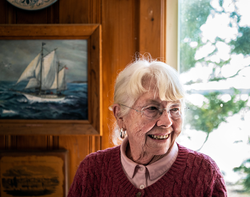 Sally Woolf-Wade stands in front of a maritime painting at her home in New Harbor on Monday, April 27. Woolf-Wade once sailed across the Atlantic on the four-masted Star Clipper. (Bisi Cameron Yee photo)