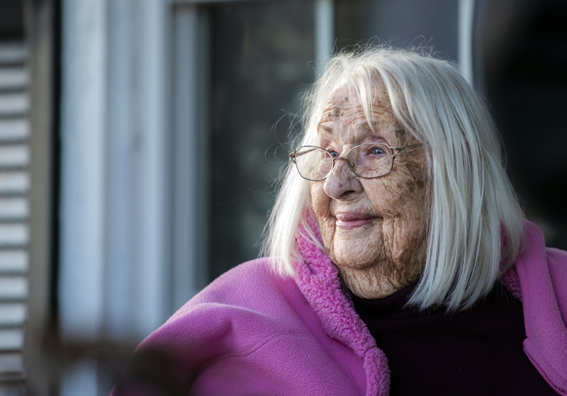 Fran Williamson observes her birthday celebration from her porch in Jefferson on Thursday, April 8. Johnston still lives on her own at 103. (Bisi Cameron Yee photo)