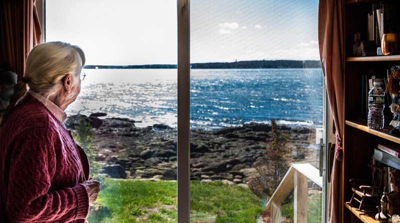 Sally Woolf-Wade looks out on John's Bay from her home in New Harbor on Monday, April 27. Woolf-Wade's father built the home as a summer cottage for family vacations. (Bisi Cameron Yee photo)