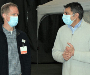 From left: Andrew Russ, associate vice president of medical affairs at LincolnHealth, talks with Nirav Shah, director of the Maine Center for Disease Control and Prevention, during a surprise visit to the Boothbay Region YMCAs Marylouise Tandy Cowan Fieldhouse in Boothbay Harbor on Saturday, April 10. (Photo courtesy John Martins)