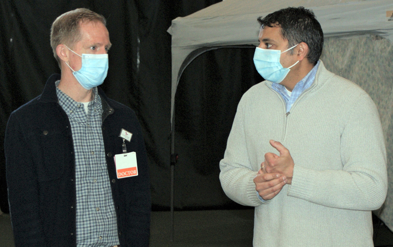 From left: Andrew Russ, associate vice president of medical affairs at LincolnHealth, talks with Nirav Shah, director of the Maine Center for Disease Control and Prevention, during a surprise visit to the Boothbay Region YMCAs Marylouise Tandy Cowan Fieldhouse in Boothbay Harbor on Saturday, April 10. (Photo courtesy John Martins)