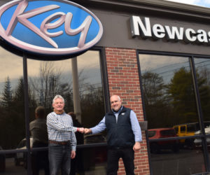 Randy Miller gives a fist bump to Key Auto Group Regional Vice President Steve "Hoaty" Houghton at Key Chrysler Dodge Jeep Ram of Newcastle on Wednesday, April 21. Miller owned the dealership for nearly 25 years and will stay on as general manager. (Evan Houk photo)