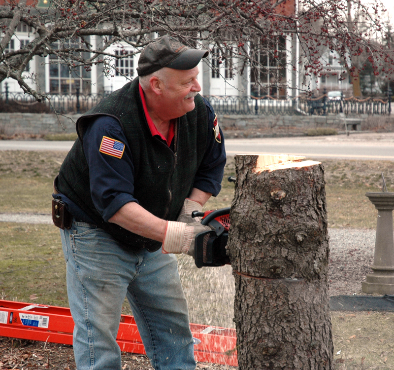 Newcastle Fire Chief Clayton Huntley cuts a tree in Veterans Memorial Park. Huntley served on the fire department for more than 50 years. (LCN file photo)