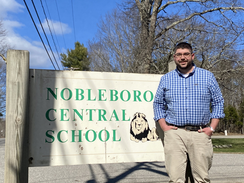Ira Michaud stands outside Nobleboro Central School on Tuesday, April 13. Michaud, currently principal of Edgecomb Eddy School, will start a new position as NCS principal July 1. (Photo courtesy Ira Michaud)