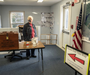 Poll worker Elaine Porter stands by the ballot box during the broadband referendum in Somerville on Tuesday, April 20. The question passed, 49-45. (Bisi Cameron Yee photo)