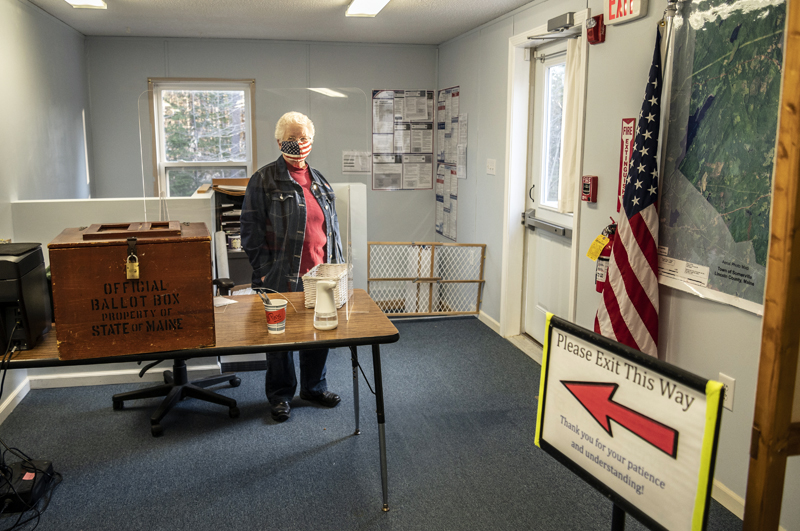 Poll worker Elaine Porter stands by the ballot box during the broadband referendum in Somerville on Tuesday, April 20. The question passed, 49-45. (Bisi Cameron Yee photo)