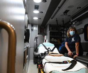 Terry Bramhall poses for a picture inside an ambulance in Waldoboro on April 1. Bramhall works at several ambulance services while also working full time at Pen Bay Medical Center and going to school to become a paramedic. (Bisi Cameron Yee photo)