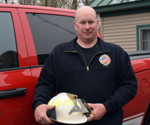 Bristol Fire Chief Scott Sutter Jr. holds the chief's helmet by the chief's truck on Thursday, April 29. Sutter became the town's second full-time fire chief effective Saturday, May 1. (Evan Houk photo)